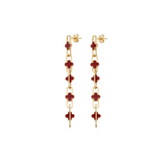 A pair of gold chain drop earrings featuring red clover motifs, shown against a plain white background.