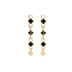 A pair of gold-tone drop earrings featuring black enamel clover motifs, rectangular chain links, and a small dangling clover charm, shown against a plain white background.