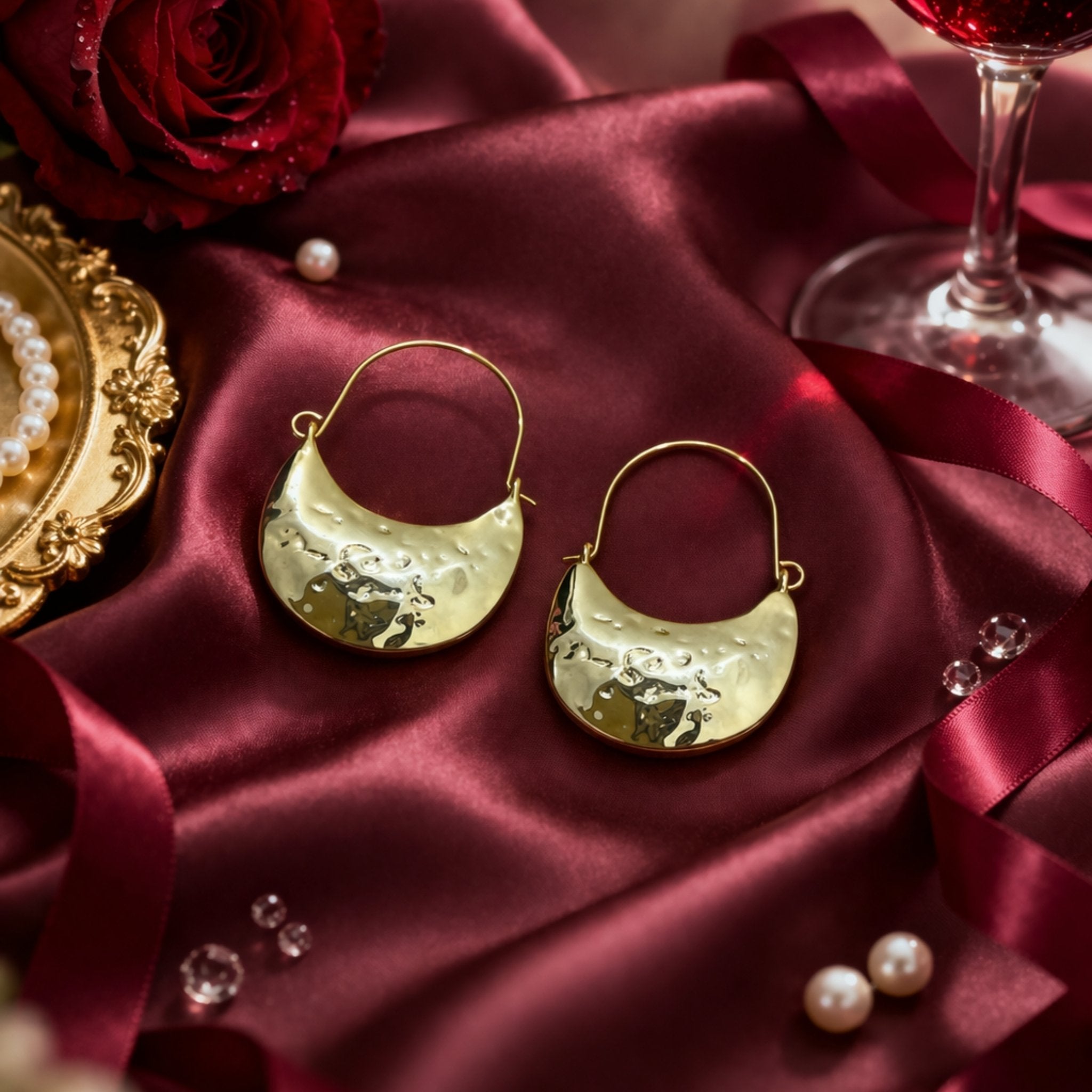 Woman wearing Luna Clutch hammered gold hoop earrings with luxury pouch-inspired Korean statement design