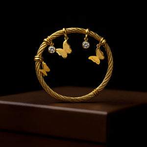 Gold butterfly charm bracelet for women by Sajna Sawarnaa, elegant designer bangle with intricate butterfly detail.