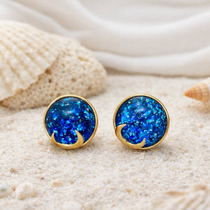 Woman wearing blue opal moon stud earrings with celestial shimmer and gold crescent detailing