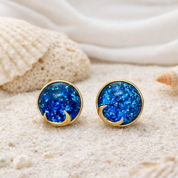 Woman wearing blue opal moon stud earrings with celestial shimmer and gold crescent detailing