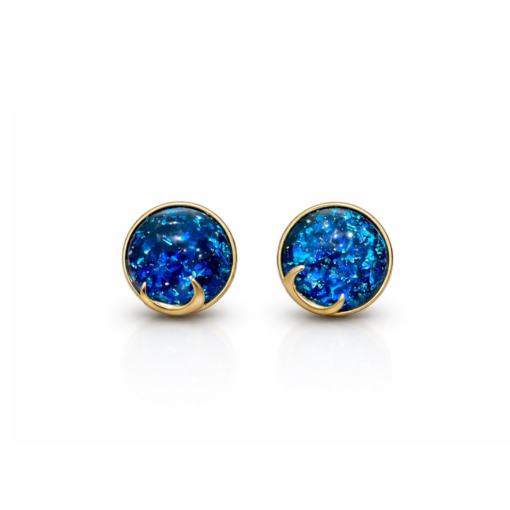 Woman wearing blue opal moon stud earrings with celestial shimmer and gold crescent detailing