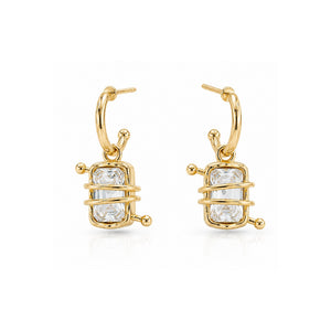 Woman wearing crystal wrapped gold hoop earrings with emerald-cut stones and modern Korean luxury design