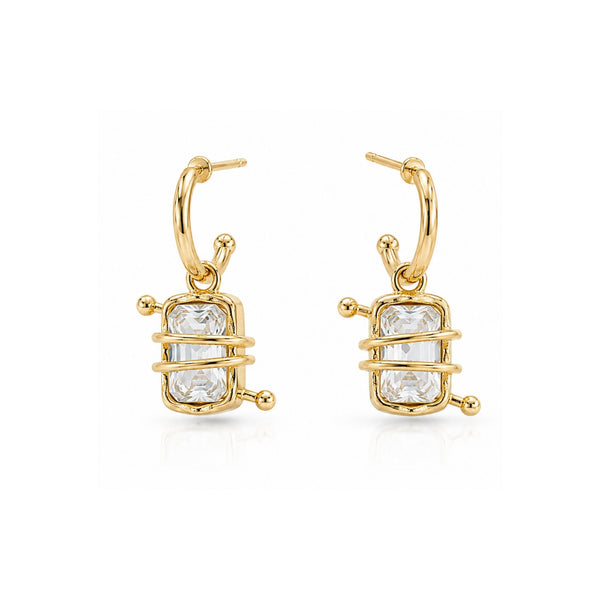 Woman wearing crystal wrapped gold hoop earrings with emerald-cut stones and modern Korean luxury design