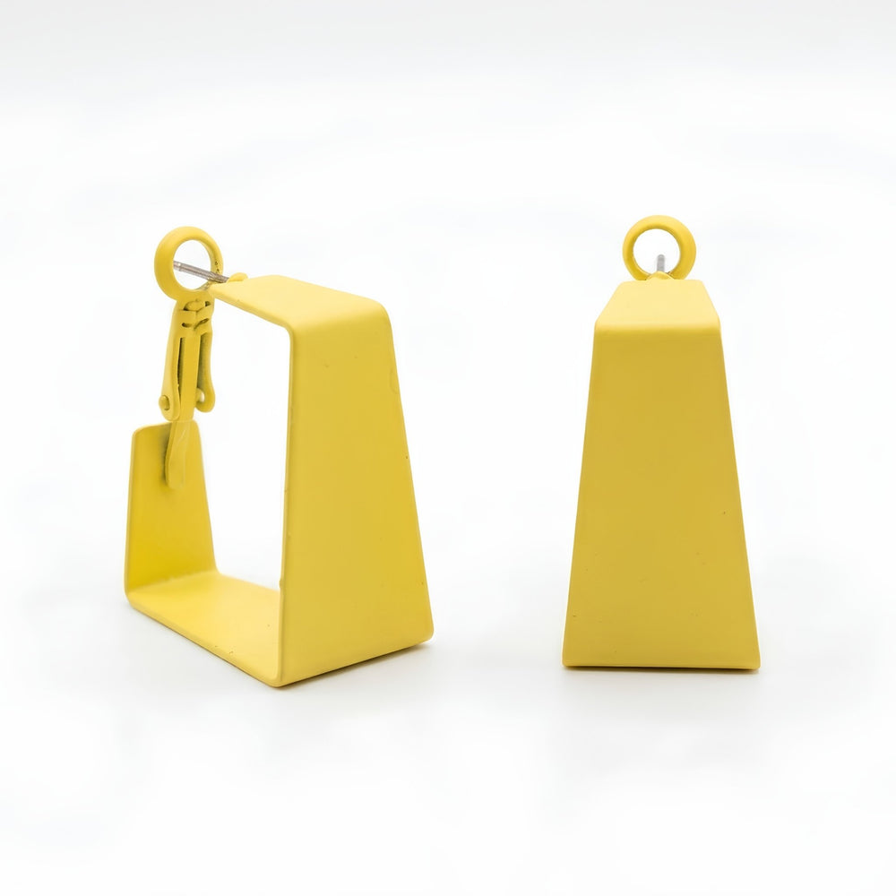 Woman wearing lime yellow geometric statement earrings with modern hollow trapeze design and trendy Korean fashion aesthetic