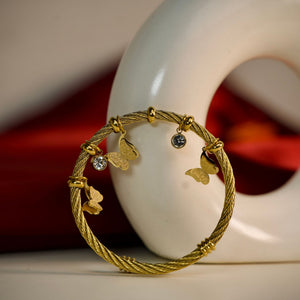 Gold butterfly charm bracelet for women featuring an elegant Sajna Sawarnaa designer bangle with intricate details.