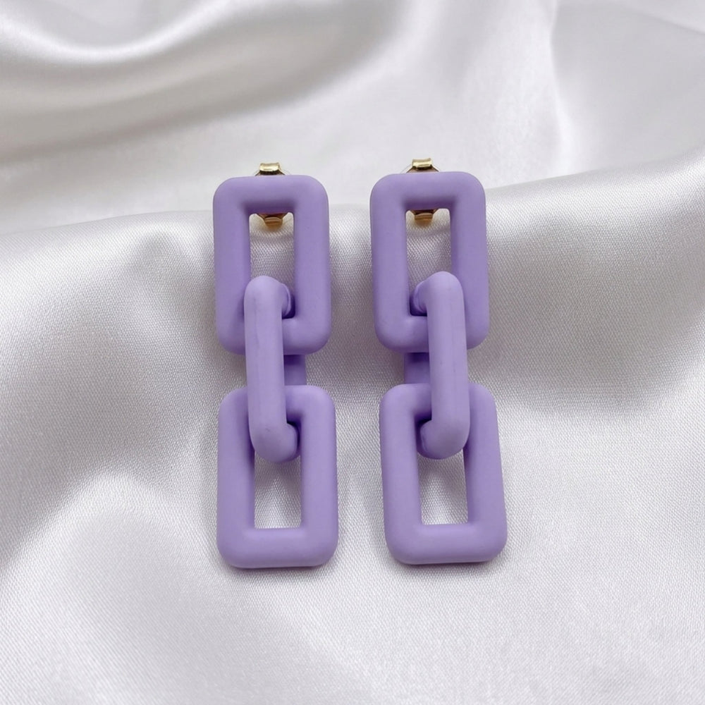 Woman wearing lavender pastel geometric chain-link statement earrings with Korean-inspired modern minimal design