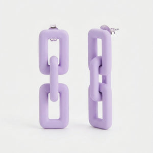 Woman wearing lavender pastel geometric chain-link statement earrings with Korean-inspired modern minimal design