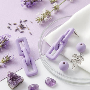 Woman wearing lavender pastel geometric chain-link statement earrings with Korean-inspired modern minimal design