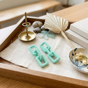 Pastel mint green geometric chain-link statement earrings with modern Korean-inspired minimal aesthetic jewelry design