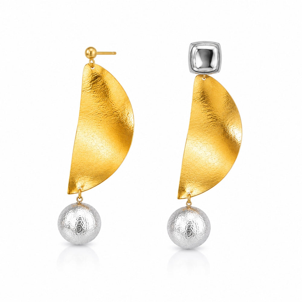 Luxury gold abstract statement earrings with textured silver pearl drops worn by a woman in elegant modern styling