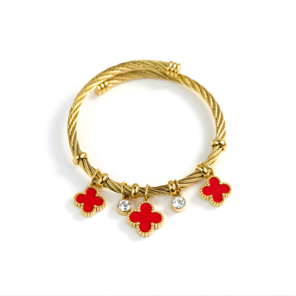 Red charm bracelet by Sajna Sawarnaa with gold finish and lucky clover accents, featuring stylish jewelry design.