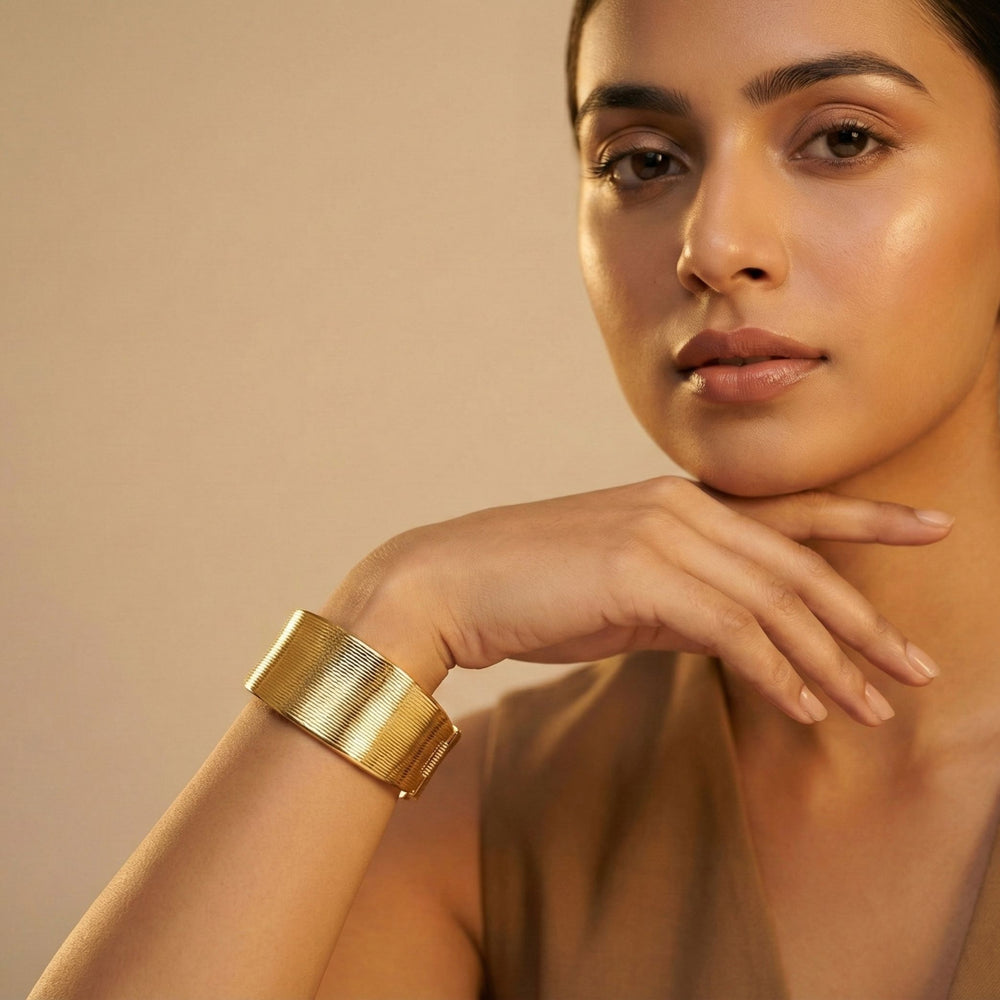 Elegant gold cuff bracelet by Sajna Sawarnaa featuring a bold statement design and anti-tarnish finish.