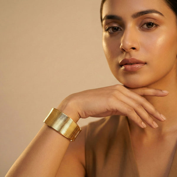 Elegant gold cuff bracelet by Sajna Sawarnaa featuring a bold statement design and anti-tarnish finish.