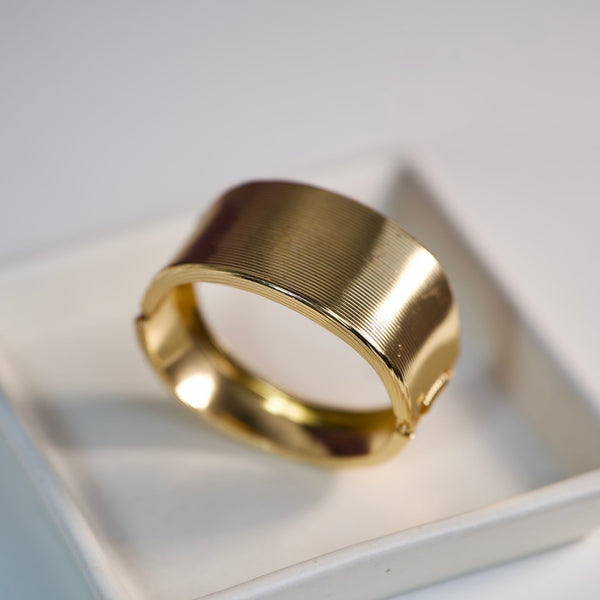 Elegant gold cuff bracelet by Sajna Sawarnaa featuring a bold statement design and anti-tarnish finish in a stylish bangle style.