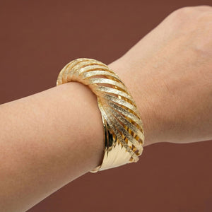 Sajna Sawarnaa women's twisted gold cuff bracelet with textured finish, luxury statement bangle, anti-tarnish jewelry.