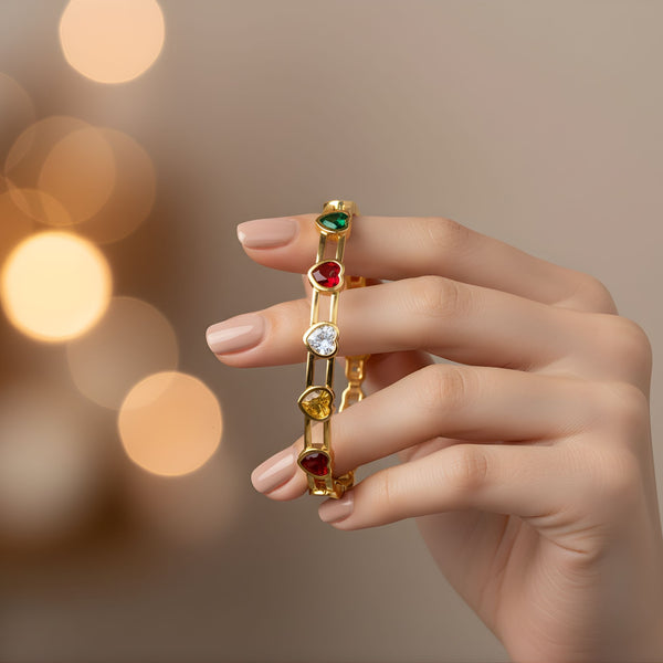 Elegant women's gold bracelet with multicolor heart gemstones by Sajna Sawarnaa, featuring a stylish bangle design.