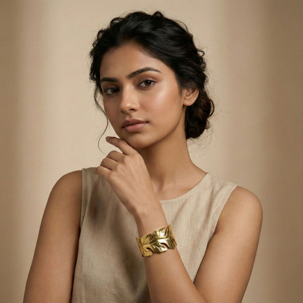 Elegant women's gold bracelet with leaf pattern open cuff design by Sajna Sawarnaa, nature-inspired jewelry for a stylish look.