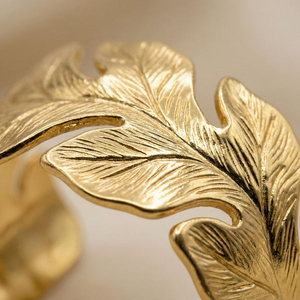 Gold women's bracelet with leaf pattern and open cuff design, stylish nature-inspired jewelry by Sajna Sawarnaa.