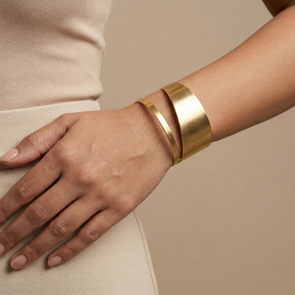 Elegant gold cuff bracelet for women with modern double layer design, showcasing luxurious jewelry style by Sajna Sawarnaa.