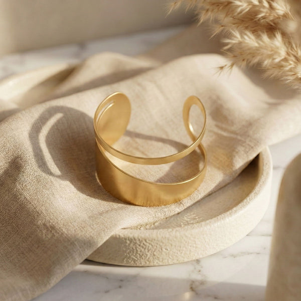 Elegant gold women's cuff bracelet with a double layer design, showcasing modern luxury jewelry by Sajna Sawarnaa.