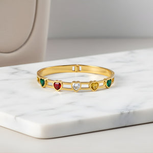 Elegant women's gold bracelet by Sajna Sawarnaa featuring multicolor heart-shaped gemstones, perfect for gifting or everyday wear.