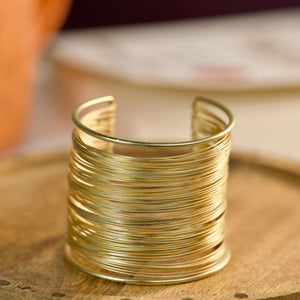 Gold layered cuff bracelet for women, multi-line stack bangle featuring elegant daily wear jewelry by Sajna Sawarnaa.