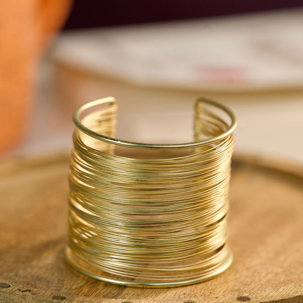 Gold layered cuff bracelet for women, multi-line stack bangle featuring elegant daily wear jewelry by Sajna Sawarnaa.