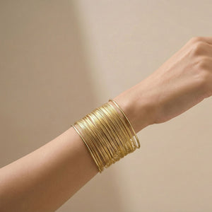 Elegant gold layered cuff bracelet for women, multi-line stack bangle jewelry by Sajna Sawarnaa, perfect for daily wear.