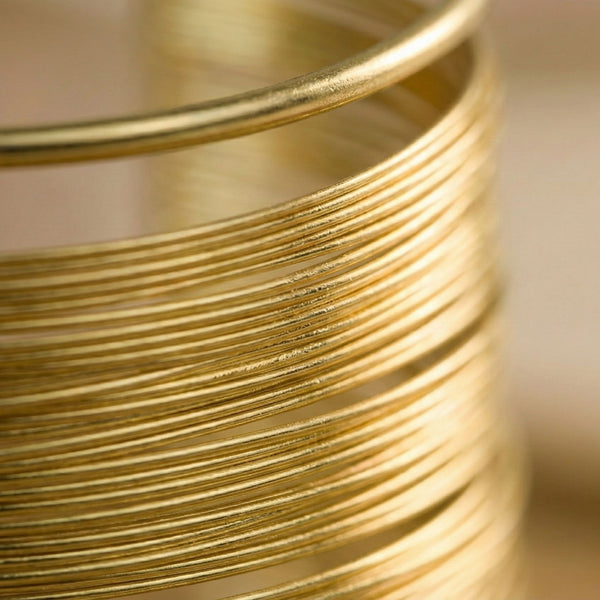 Gold layered cuff bracelet for women featuring multiple thin bangles, elegant daily wear jewelry by Sajna Sawarnaa.