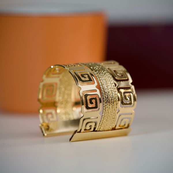 Royal gold statement cuff bracelet for women with Greek pattern, wide kada design, perfect for party wear by Sajna Sawarnaa.