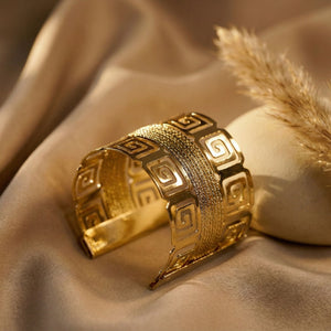 Royal gold statement cuff bracelet for women with Greek pattern, wide kada design, perfect for elegant party wear jewelry.