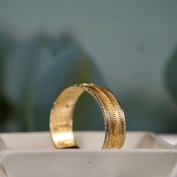 Women’s gold wide cuff bracelet with textured design for everyday elegance, crafted by Sajna Sawarnaa.