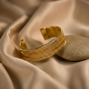 Women's gold wide cuff bracelet by Sajna Sawarnaa with textured design, perfect for everyday elegance and stylish accessories.