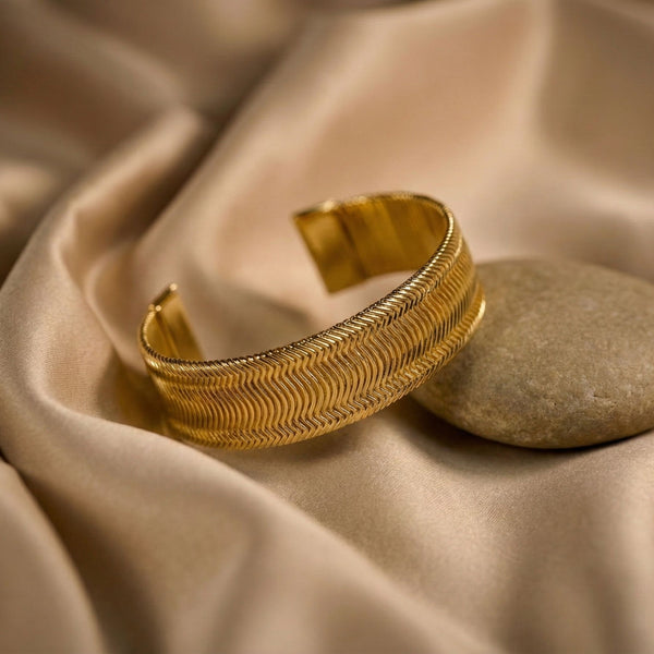 Women's gold wide cuff bracelet by Sajna Sawarnaa with textured design, perfect for everyday elegance and stylish accessories.