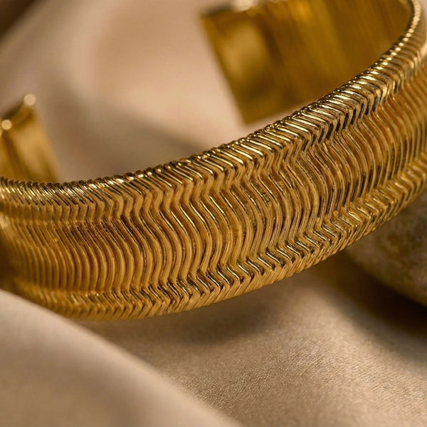 Women’s gold wide cuff bracelet by Sajna Sawarnaa with textured design, perfect for everyday elegance and stylish accessorizing.