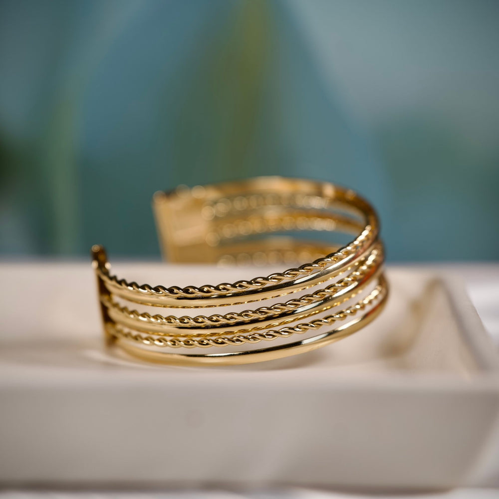 Gold layered cuff bracelet for women by SAJNA SAWARNAA, featuring a stylish multi-line open kada design.