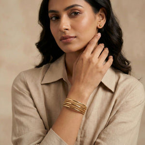 Gold layered cuff bracelet for women by SAJNA SAWARNAA featuring multiple open kada lines and intricate design details.