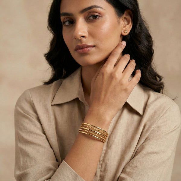 Gold layered cuff bracelet for women by SAJNA SAWARNAA featuring multiple open kada lines and intricate design details.