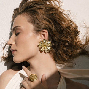 Gold plated bold floral statement earrings for women with intricate flower design, by SAJNA SAWARNAA.