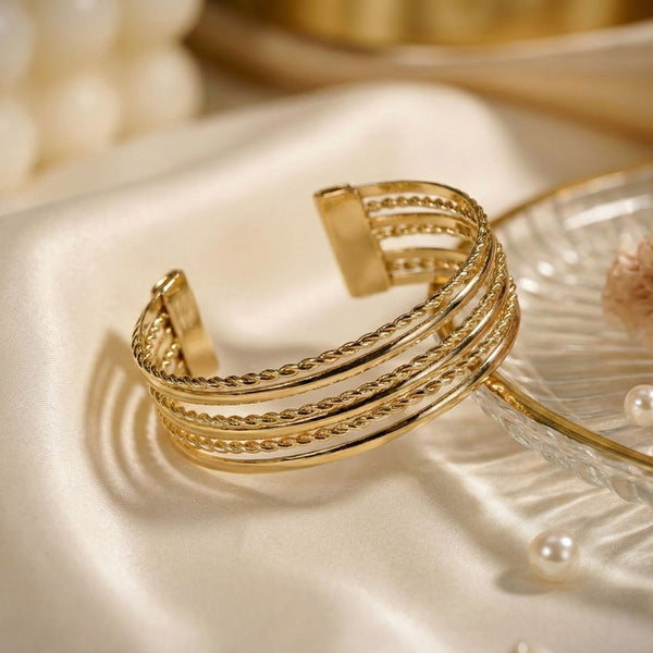 Gold layered cuff bracelet for women by SAJNA SAWARNAA, featuring a multi-line open kada design with intricate details.