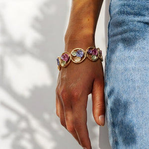 Gold floral enamel circle bracelet by SAJNA SAWARNAA featuring Korean anti-tarnish jewelry design and intricate floral details.