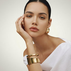 Elegant modern gold cuff bracelet for women featuring a double layer design, stylish and versatile jewelry by Sajna Sawarnaa.