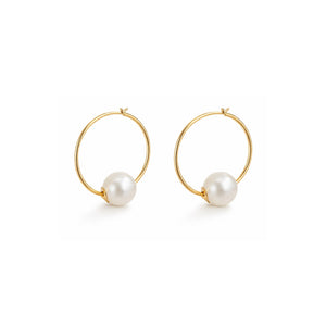 Gold hoop earrings with pearl beads on a white background