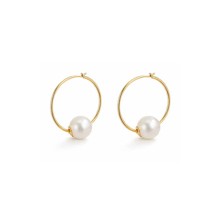 Gold hoop earrings with pearl beads on a white background