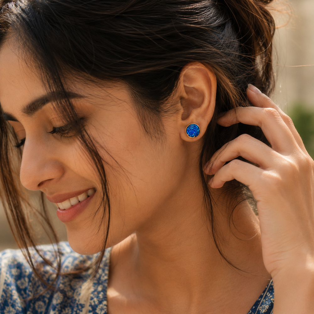 Woman wearing blue opal moon stud earrings with celestial shimmer and gold crescent detailing