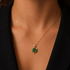 Woman wearing a gold-tone green cat charm necklace