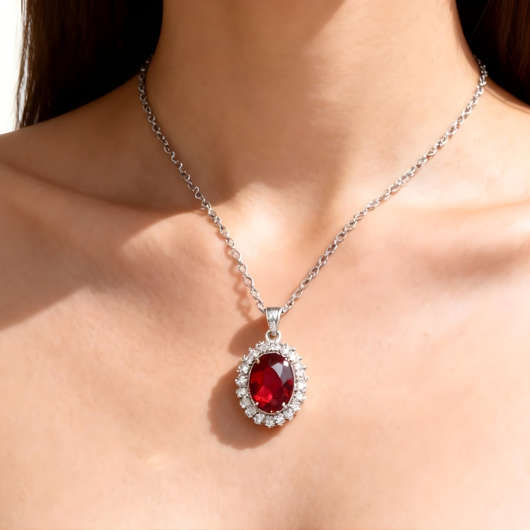 Woman wearing a silver-tone red stone-accent oval pendant necklace