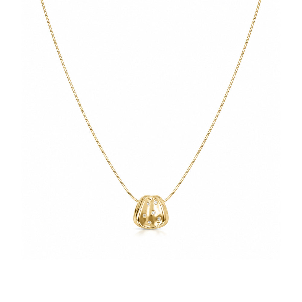 Gold-tone organic pendant necklace with clear stone accents on a white background